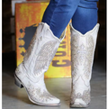 Cream-colored, bejeweled wing-embroidered, pointed-toe, mid-heeled, western-style cowboy boots for women are ideal for a chic everyday fashion look.